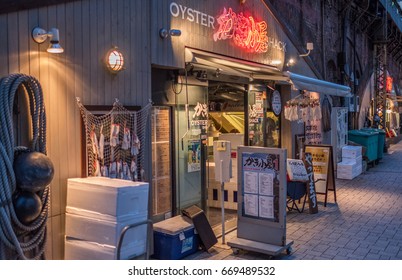TOKYO, JAPAN - JUNE 30TH 2017. Restaurants and local bars (izakaya) along the Japan Railway track. Known as Gado Shita, it attracts office workers for its cheap and delicious food and drinks,