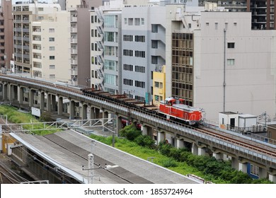 TOKYO, JAPAN - June 5, 2019: Overhead View Of A Freight Train Running In Central Tokyo. Kameido Train Station Is In The Foreground.