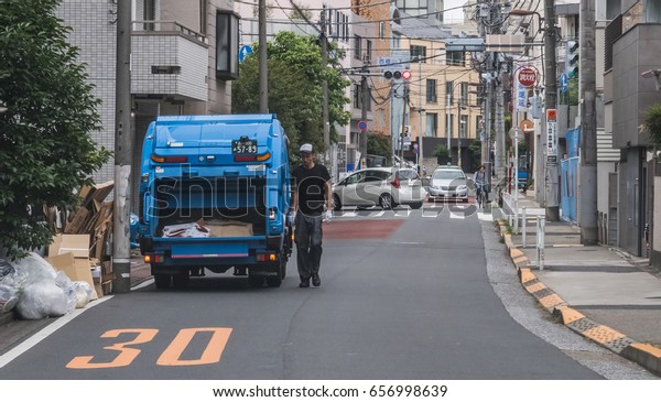 TOKYO, JAPAN - JUNE 8TH, 2017. Garbage truck in Tokyo\
street. In Tokyo, trash has to be divided into three categories,\
combustible trash, non-combustible trash, recyclable trash for\
proper disposal. 