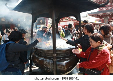 Tokyo, Japan - March 13, 2017: People gathered in front of Sensō-ji temple around the incense holder.