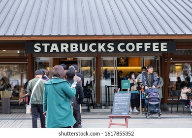 Tokyo, Japan - March 17, 2019:View Of Customers Waited In The Queue At Starbucks Coffee Ueno Onshi Park During Pink Cherry Blossom Or Sakura Spring Season In Tokyo, Japan.