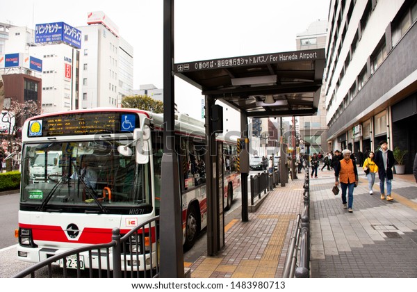 TOKYO, JAPAN - MARCH 30 : Traffic road cityscape\
andbus station at front of Kamata station with japannese people\
walking go to work in Kamata at Ota City in Kanto on March 30, 2019\
in Tokyo, Japan