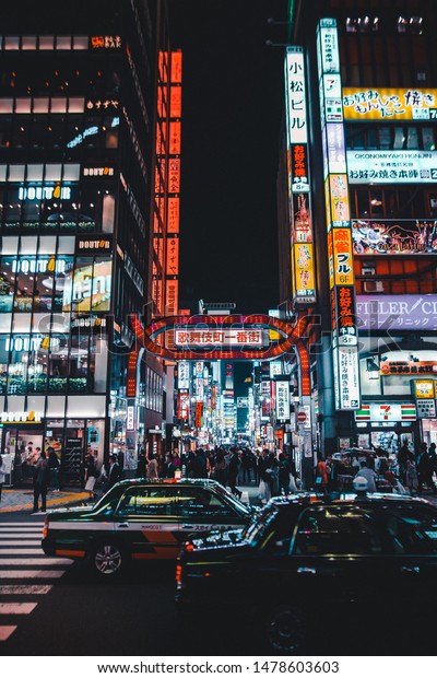 Tokyo, / Japan March 30th 2019\
: Photograph of a street downtown Tokyo, with a lot of neon\
lights.