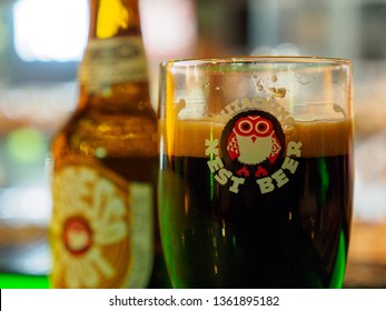 TOKYO, JAPAN - MARCH 31, 2019: Closeup Macro Detail Of A Glass Of Hitachino Nest Espresso Stout Beer Nest To A Bottle On A Bar Counter. Travel And Tourism.