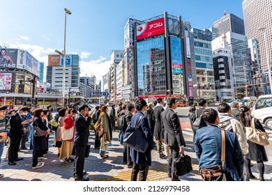 Tokyo, Japan - March 31, 2019: Shinjuku Sidewalk Ome-Kaido Avenue Street Road With Busy Crowd Many People Waiting To Cross Road In Morning Rush Hour Commute In Downtown District