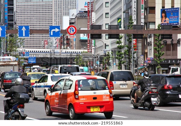 TOKYO, JAPAN - MAY 11, 2012: People drive cars in\
Tokyo. With 591 vehicles per capita, Japan is a country with one of\
highest car ownership\
rates.