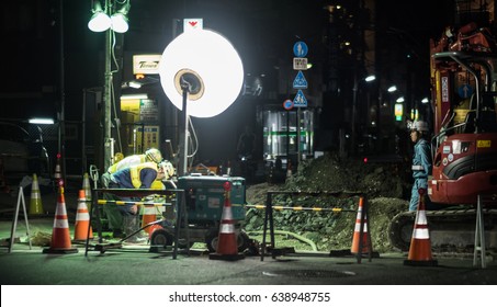 TOKYO, JAPAN - MAY 12TH, 2017. Construction Workers Working At Night In The Streets Of Tokyo, Japan. Construction Industry, The Mainstay Of Infrastructure Development In Japan.