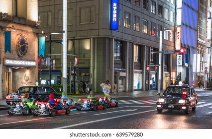 TOKYO, JAPAN - MAY 13TH, 2017. Rental Go Karts In Ginza Street. Driving A Go Kart In Public Street Offer People The Chance To Go Through Tokyo’s Busy Streets And Is A Popular Activity With Tourists.
