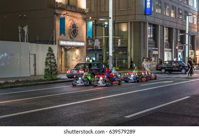 TOKYO, JAPAN - MAY 13TH, 2017. Rental Go Karts In Ginza Street. Driving A Go Kart In Public Street Offer People The Chance To Go Through Tokyo’s Busy Streets And Is A Popular Activity With Tourists.
