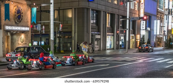 TOKYO, JAPAN - MAY 13TH, 2017. Rental Go Karts In Ginza Street. Driving A Go Kart In Public Street Offer People The Chance To Go Through Tokyo’s Busy Streets And Is A Popular Activity With Tourists.
