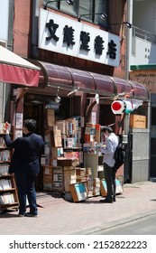 TOKYO, JAPAN - May 5, 2022: People Browsing Outside A Used Bookstore In Tokyo's Jinbocho Area.