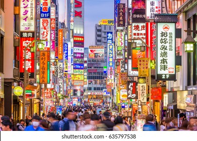 TOKYO, JAPAN - MAY 7, 2017: Crowds pass through Kabukicho in the Shinjuku district. The area is an entertainment and red-light district.