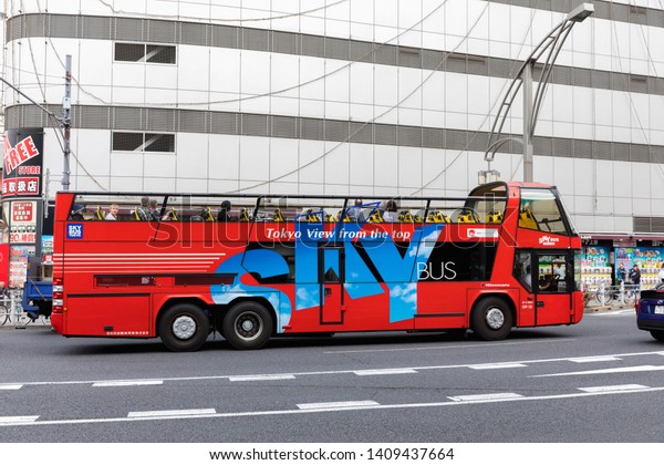 Tokyo, Japan - May\
9, 2019: Sky Bus passes through Tokyo\'s Ueno district, operated by\
Hinomaru Jidosha Kogyo, a tourist bus operator. The first open top\
tourist bus in Japan.