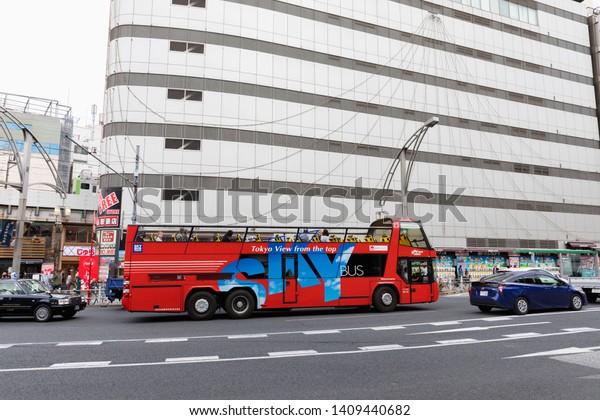 Tokyo, Japan - May\
9, 2019: Sky Bus passes through Tokyo\'s Ueno district, operated by\
Hinomaru Jidosha Kogyo, a tourist bus operator. The first open top\
tourist bus in Japan.