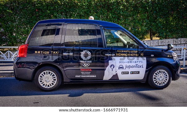 TOKYO, JAPAN - NOVEMBER 12,\
2019 : A Toyota JPN Taxi with Tokyo Olympic 2020 logo on its side,\
Japan.