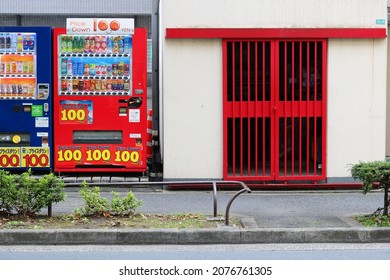 TOKYO, JAPAN - November 18, 2021: A Pair Of Drinks Vending Machine Stocked With Hot And Cold Drinks By A Street In Tokyo's Edogawa Ward.