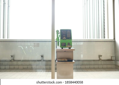 Tokyo, Japan - November 19 2020: Japanese Green Pay Phone Against A Bright, White Background.