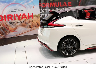 TOKYO, JAPAN - November 20, 2019: The Back Of A Nissan Leaf With A Poster For A Formula E Championship To Be Held In Saudi Arabia In The Background At Nissan Crossing Showroom In Ginza Place.