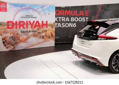 TOKYO, JAPAN - November 20, 2019: The Back Of A Nissan Leaf With A Poster For A Formula E Championship To Be Held In Saudi Arabia In The Background At Nissan Crossing Showroom In Ginza Place.