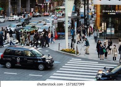 TOKYO, JAPAN - November 20, 2019: Overhead View Of Ginza's Busy 4-Chome Crossing. Some Motion Blur.