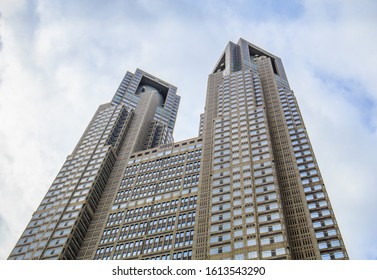 TOKYO, JAPAN - NOVEMBER 3, 2019: A Low Angle Front View Of The Imposing Twin Towers Of The Tokyo Metropolitan Government Building In Shinjuku, Tokyo.