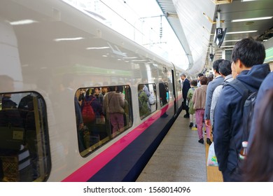Tokyo, Japan - Oct. 28, 2019: Japanese people neatly lined up to get on the train.