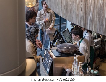 TOKYO, JAPAN - OCTOBER 14TH, 2017. Starbucks Staff Working Behind The Counter In Its Shibuya Coffee House Outlet.