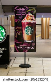 TOKYO, JAPAN - October 21, 2021: Sign By Starbucks Coffee Shop Advertising A Seasonal Sweet Potato And Chocolate Halloween Trick Or Treat Drink. It's In Tokyo's Ueno Station.