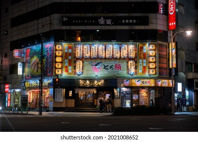 Tokyo, Japan - October 22, 2019: The night illumination of traditional japanese restaurants at Ningyocho Station. Izakaya Toro Sushi, Ramen Big Echo karaoke and Yokohama family ramen. Tokyo. Japan