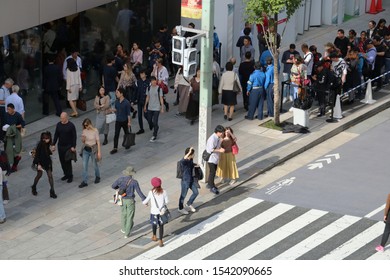 TOKYO, JAPAN - October 27, 2019: Overhead View Of The Apple Store In Ginza And The Busy Sidewalk In Front Of It. People On The Left Are Waiting In Line To Buy The Latest Iphones.