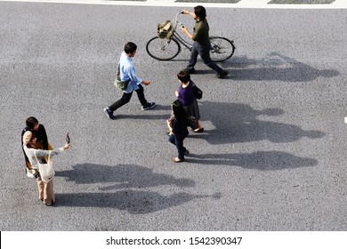 TOKYO, JAPAN - October 27, 2019: Overhead View Of A Street In Ginza With People Walking & People Taking A Selfie. It's A So-called 'pedestrian Paradise Day' So The Road Is Closed To Cars.