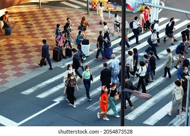 TOKYO, JAPAN - October 8, 2021: Overhead View Of People Using A Crosswalk By Ueno Station. Some Motion Blur.