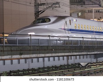 TOKYO, JAPAN - SEPTEMBER 15TH, 2018. Japan High Speed Bullet Train Passing Through Yurakucho Station Railway Track At Night. Selective Focus.