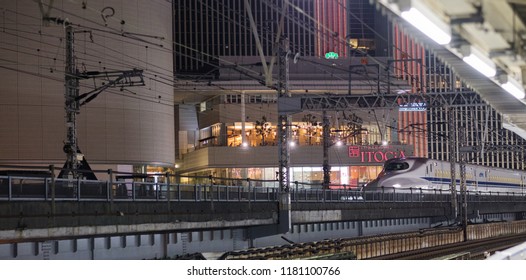 TOKYO, JAPAN - SEPTEMBER 15TH, 2018. Japan High Speed Bullet Train Passing Through Yurakucho Station Railway Track At Night. Selective Focus.