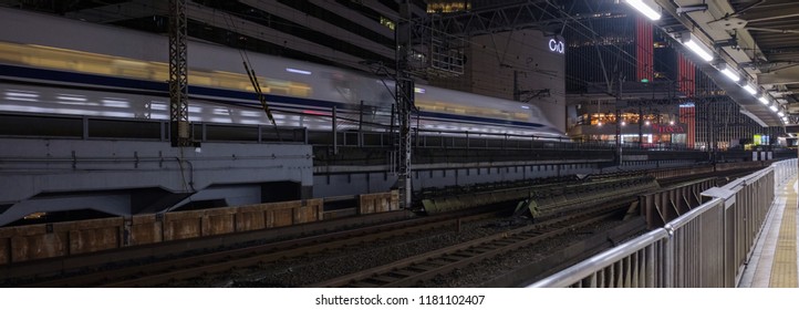 TOKYO, JAPAN - SEPTEMBER 15TH, 2018. Blurred Motion Image Of Japan High Speed Bullet Train Passing Through Yurakucho Station Railway Track At Night.