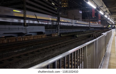 TOKYO, JAPAN - SEPTEMBER 15TH, 2018. Blurred Motion Image Of Japan High Speed Bullet Train Passing Through Yurakucho Station Railway Track At Night.