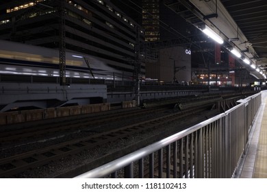 TOKYO, JAPAN - SEPTEMBER 15TH, 2018. Blurred Motion Image Of Japan High Speed Bullet Train Passing Through Yurakucho Station Railway Track At Night.