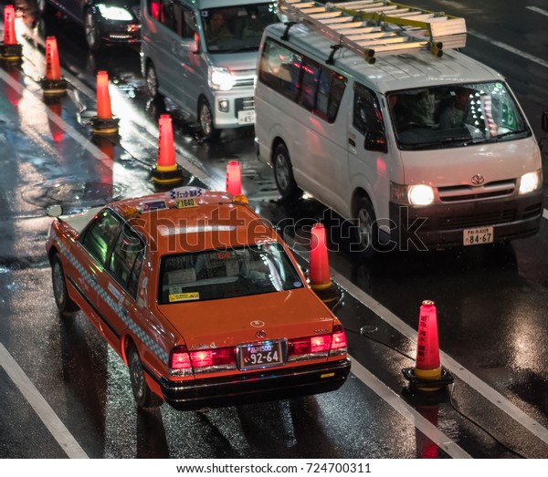 TOKYO, JAPAN - SEPTEMBER 28TH,\
2017. Public taxi in the street of Shibuya during a rainy\
night.