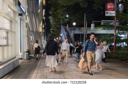 TOKYO, JAPAN - SEPTEMBER 8TH, 2017. People Walking At Omotesando Street Sidewalk At Night.