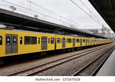 Tokyo, JP - OCTOBER 31, 2018: The Old Vintage Yellow Local Train Stopping On Seibu Ikebukuro Line, Waiting For Passengers.