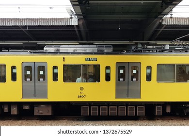 Tokyo, JP - OCTOBER 31, 2018: The Old Vintage Yellow Local Train Stopping On Seibu Ikebukuro Line, Waiting For Passengers.