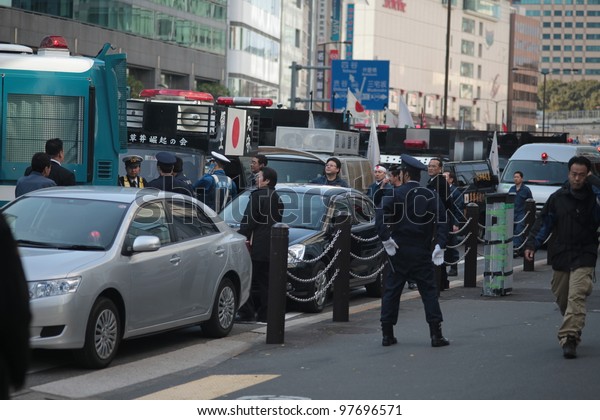 TOKYO - MARCH 11: Police stopping right-wing\
protesters near the Imperial Palace on March 11, 2012 in Japan.\
Radicals often use public holidays and anniversaries to promote\
nationalist propaganda.