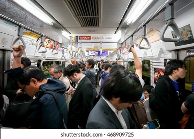 TOKYO - MAY 16, 2014: Japanese People Standing Inside Subway Carriage In Tokyo