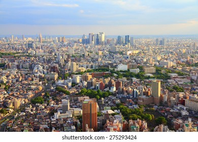 Tokyo skyline - city aerial view with Toshima and Shinjuku wards. Warm sunset light.