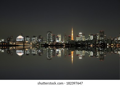 Tokyo Skyline At Night Reflected In Water