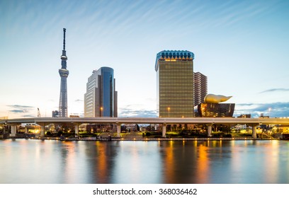 Tokyo skyline on the Sumida River at twilight.