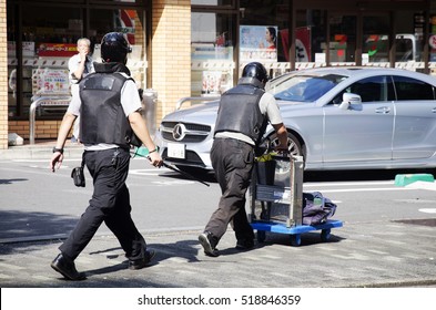 TOKYO, THAILAND - OCTOBER 19 : Japanese People Armored Guard Transporting Money Or Security Guard For Move Money Working On The Road In Shinjuku Of Kanto Region On October 19, 2016 In Tokyo, Japan