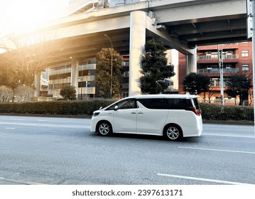 Tokyo,Japan - Januari 01,2023 ; A white Toyota Alphard passes on the highway.