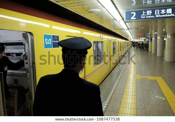 TOKYO,JAPAN - March 28,2015\
:Train driver waiting passenger enters the train at Train\
station,Tokyo,Japan