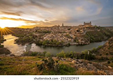 Toledo aerial panoramic skyline view of historic Old Town district with Tagus River, churches, cathedral, alcazar, museums, ancient city walls and squares. Toledo, Spain panorama cityscape at sunrise. - Powered by Shutterstock